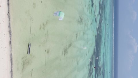 Vertical video kitesurfing near the shore of Zanzibar, Tanzania, aerial view