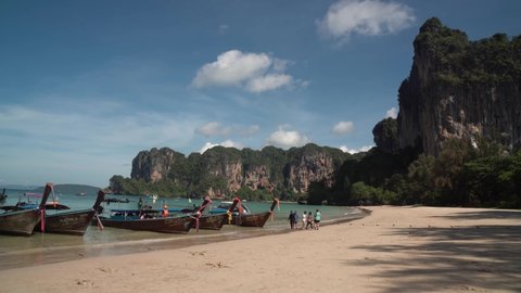 Railay Krabi Thailand : 25 Apr 2022 :  Landscape of Traditional Thailand Long tail Boat on Railay Beach white sand and blue sea with limestone in Railay Ao nang Krabi Thailand - sunny day summer