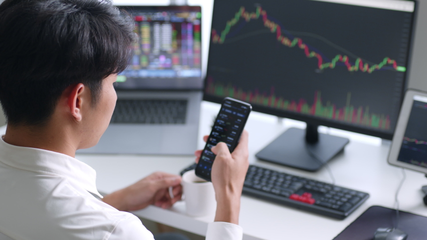 Young Asian investor watching the change of cryptocurrency and stock market on smartphone. | Shutterstock HD Video #1089781763