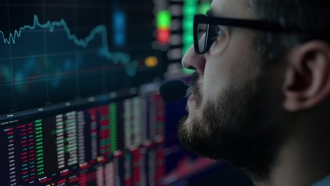 Trader is working with multiple computer screens full of charts and data analysis and stock broker trading online. Concept of bitcoin and stock market trading.