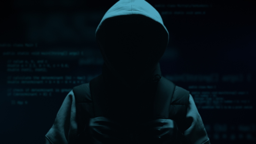 Computer hacker with hoodie. Computer abstract digital code at the background. Darknet fraud and cryptocurrency bitcoin concept. Cybersecurity and data protection in social network | Shutterstock HD Video #1089782071