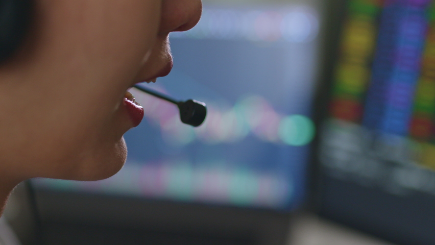 Close up of young Asian woman broker wearing headphone, call center, customer service talking with customer and trading stock. - Powered by Shutterstock - Get 15% off with code: PIKWIZARD15