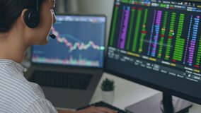Young Asian woman broker wearing headphone, call center, customer service talking with customer and trading stock. - Powered by Shutterstock - Get 15% off with code: PIKWIZARD15