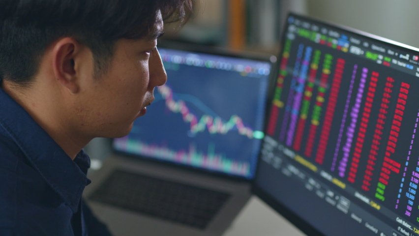 Young Asian investor man watching the change of stock market and trading stock on computer laptop screen. | Shutterstock HD Video #1089782637