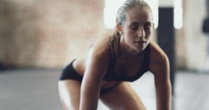 Strength comes from within. 4k video of an attractive young woman pumping iron in the gym.