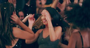 The night is not just for sleeping. 4k video footage of young women dancing and hugging in a club.