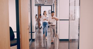 4k video footage of a group of coworkers walking through the office on the way to a meeting