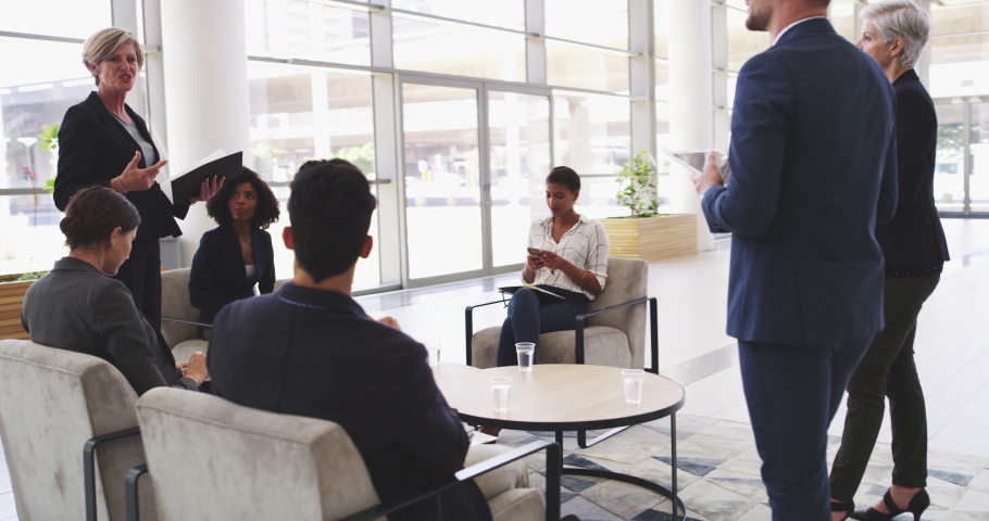 Briefing them on upcoming projects. 4k video footage of businesspeople having a meeting in the workplace. Royalty-Free Stock Footage #1089783201
