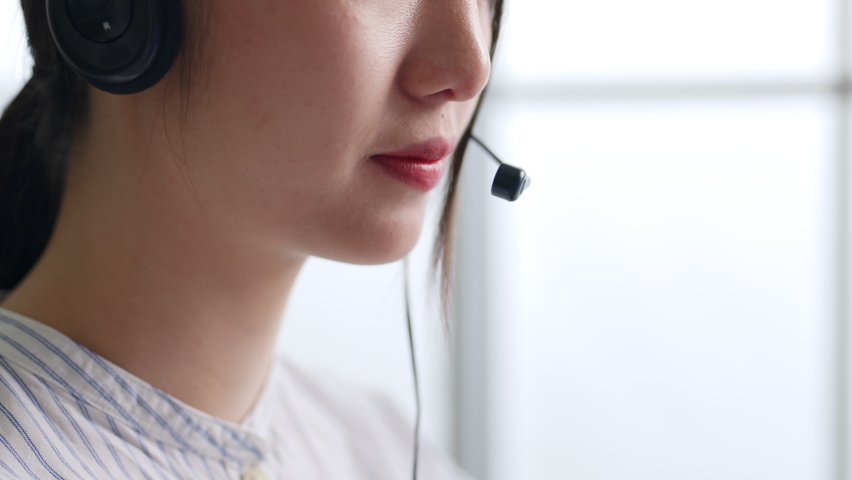 Closeup Asian woman call center, customer service, telesales in formal suit wearing headset or headphone talking with customer in office Royalty-Free Stock Footage #1089783769