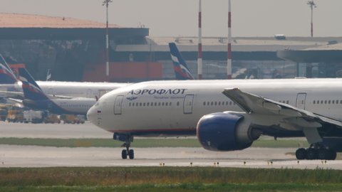 MOSCOW, RUSSIAN FEDERATION - JULY 29, 2021: Boeing 777 of Aeroflot taxis on the runway at Sheremetyevo Airport (SVO). Long shot, airplane Aeroflot airport terminal