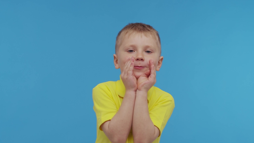 Portrait of happy smiling boy in t-shirt. Attractive and expressive kid in studio.