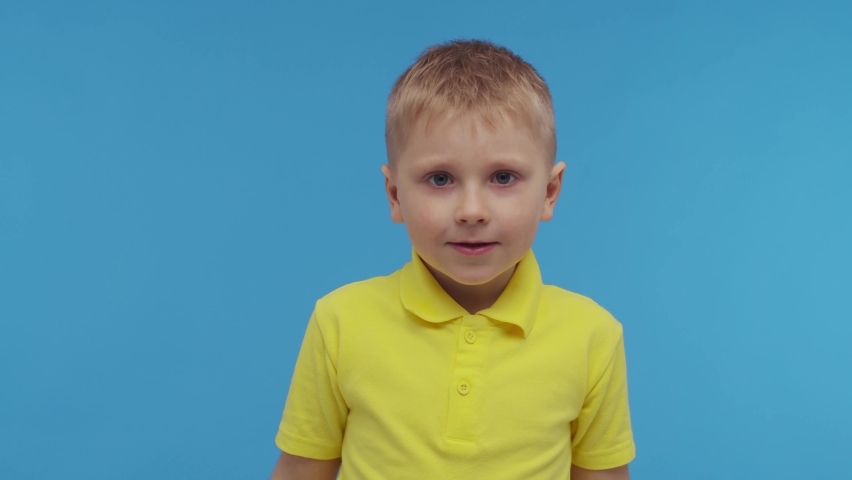 Portrait of happy smiling boy in t-shirt. Attractive and expressive kid in studio.
