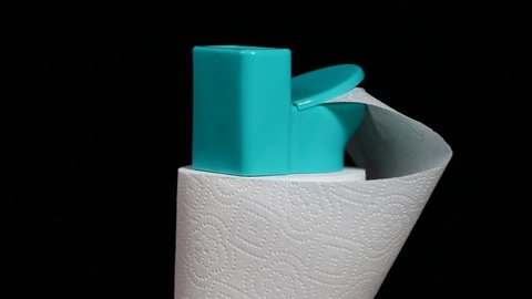 footage of miniature toilet paper dark background 