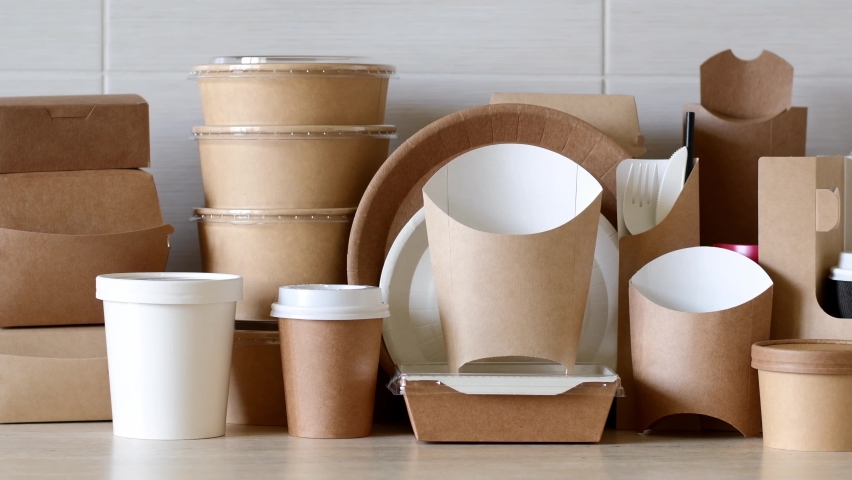 Paper eco-friendly disposable tableware. A large set of dishes and packaging for fast food. Panorama. Royalty-Free Stock Footage #1089791383