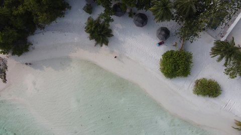 Aerial view of beautiful Maldives island beach villa bungalows resort, top view 4K Sun island drone landscape with swimming pools bungalows