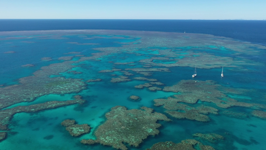 flying over the great barrier reef in the whitsundays, over a yacht, in queensland, Australia.
