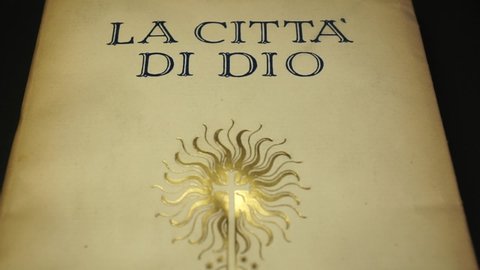 Rome, Italy - April 16, 2022, detail of the cover of an ancient book, The City of God by the philosopher Aurelio Agostino d'Ippona who entered history as Saint Augustine.