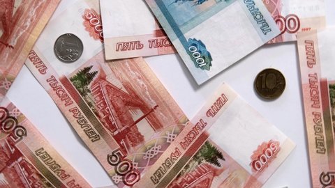 Russian rubles banknotes and coins spinning background. Payment in rubles concept. Financial crisis, ruble devaluation or strengthening. Slow motion