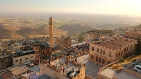 Mardin old town cityscape at sunset. Traditional stone houses of Mardin. Popular tourist destination in Eastern Turkey. Slow revealing shot