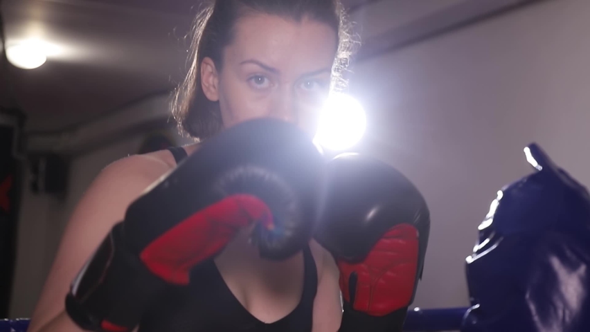 Aggressive female boxer practices punches in training. Fast hand movements, fight with the shadow Royalty-Free Stock Footage #1089803443