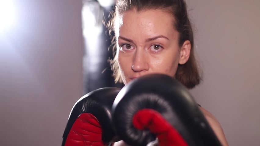 Aggressive female boxer practices punches in training. Fast hand movements, fight with the shadow Royalty-Free Stock Footage #1089803447