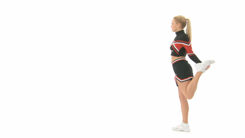 Cheerleader raises her left leg behind her head, holds it and stretches out her