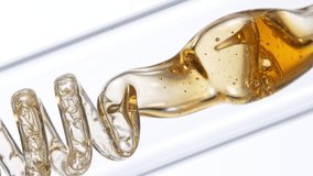 Getting natural oil from natural substances and flowers. Yellow oil flows in a spiral. Super slow motion filmed on high speed cinematic camera. - Powered by Shutterstock - Get 15% off with code: PIKWIZARD15