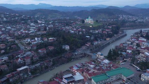 View from drone of historical districts of old Georgian city of Kutaisi on both sides of Rioni river with rebuilt building
