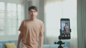 Display Smartphone Of Asian Man Dancing While Shooting Video Content For Social Networks
