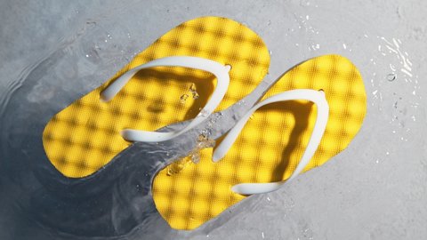 Super Slow Motion Shot of Yellow Flip Flops Splashing Into Clear Sea Water at 1000 fps, Vacation Concept.