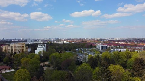 Perfect fluffy clouds in the blue sky over the capital of Germany. Gorgeous aerial view flight fly backwards drone footage of Berlin Tempelhof Park Spring 2022. Cinematic view above by Philipp Marnitz