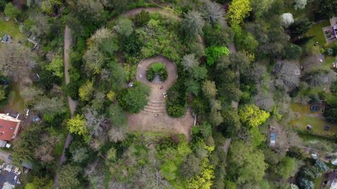 Trees Stairs and a monument Stunning aerial view flight rotation 360 drone shot bird's eye view drone footage of Berlin Tempelhof Park District Spring 2022 Cinematic view from above by Philipp Marnitz