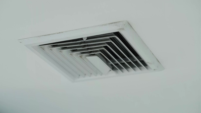 Air vent on a ceiling, pans to air vent cover on office ceiling, Plastic ventilation grid, piece of home ventilation system. Royalty-Free Stock Footage #1089813501
