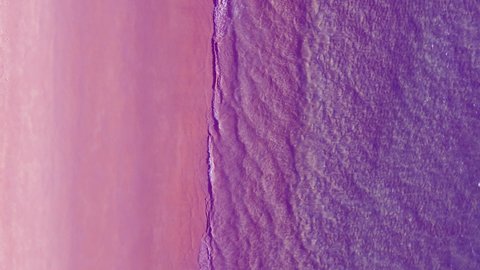 Aerial view of drone. Slow motion Scene of Pink beach top view beach and pink seawater on sandy beach in summer. Nature and travel concept.