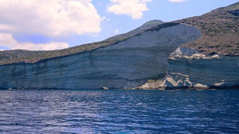 Eroded steep cliff coastline on the scenic island of Milos, Greece 