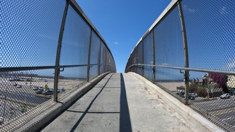 View crossing Pacific Coast Highway on a Santa Monica beach pedestrian bridge in Los Angeles County, California.