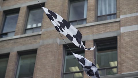 Close up of a banner of checkered flags blowing in the wind 