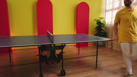 Concept of sport and healthy lifestyle closeup to the camera two players of table tennis or ping pong shaking hands after they end the game. 4k