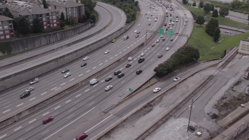 Atlanta Georgia Aerial Tilt Up from Busy Highway to City Skyline on Cloudy Day