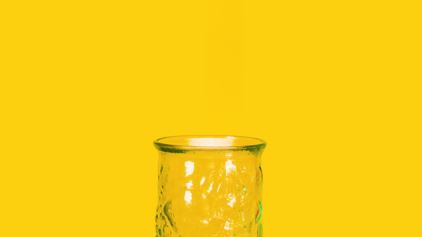 Pouring fresh orange juice in a drinking glass. Splashing isolated healthy beverage for breakfast in the morning. | Shutterstock HD Video #1089823727