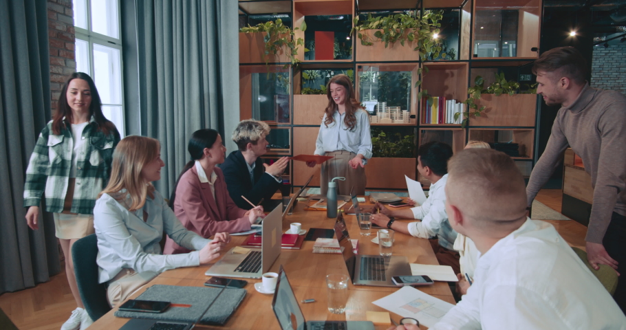 Young beautiful successful female team leader, executive businesswoman gives presentation work meeting at modern office.