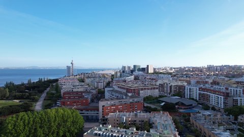 DRONE PAN AERIAL FOOTAGE: The Vasco da Gama Bridge and the Vasco da Gama Tower at Park of Nations in Lisbon. Modern residential neighborhood with contemporary architecture.