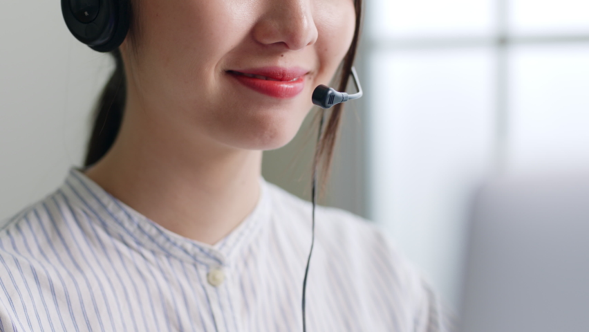 Closeup Asian woman call center, customer service, telesales in formal suit wearing headset or headphone talking with customer in office Royalty-Free Stock Footage #1089827493