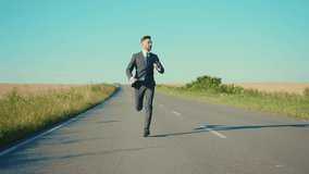 Slow motion businessman runs talking on a smartphone country road near a wheat field freedom concept outdoors handsome winner elegant close up - Powered by Shutterstock - Get 15% off with code: PIKWIZARD15