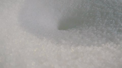 The polypropylene granules fall into the funnel. Polypropylene granules. Polypropylene granules close-up. Nonwoven Fabric Factory