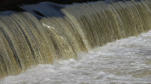 Water at the weir of a hydroelectric power plant in slow motion