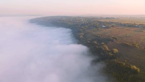 Spectacular valley are covered with thick morning fog. Footage from a bird's eye view. Location place Dniester canyon, Ukraine, Europe. Cinematic drone shot. Filmed in UHD 4k video. Beauty of earth.