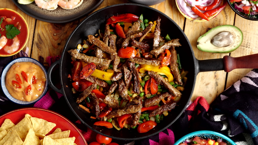 Fajitos fajita fajitas is a popular Mexican dish of meat and vegetables, cut into strips and grilled Royalty-Free Stock Footage #1089830333