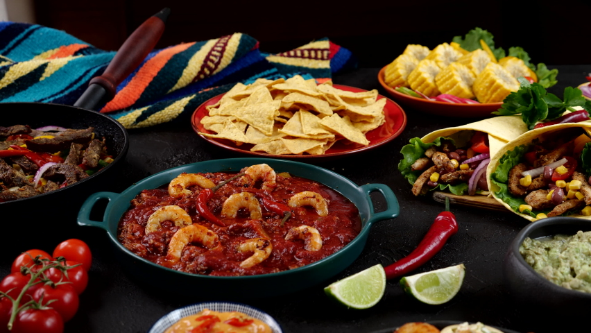 Cinco de mayo celebration. Traditional mexican shrimp soup, Pico de gallo, Nachos, Guacamole, Corn Tortilla chip, Salsa, Burrito Royalty-Free Stock Footage #1089830335
