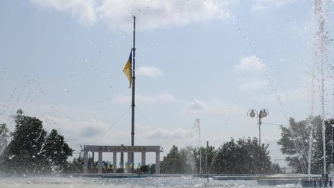 MELITOPOL, ZAPORIZHIA OBLAST, UKRAINE - JUNE 19 2021: raising the Ukrainian flag in the center of melitopol